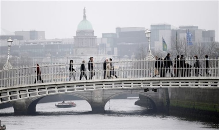 People stroll across a bridge over the river Liffey in central Dublin, Ireland. The country  has long been one of the world's most popular tourist destinations, particularly for Americans, some 40 million of whom have Irish heritage.